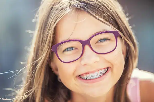 young girl smiling with braces