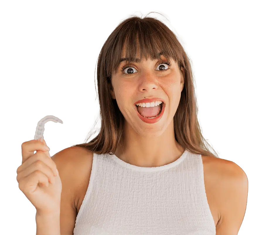 young-woman-holding-invisible-braces-outdoors-with-surprise-shocked-facial-expression-min