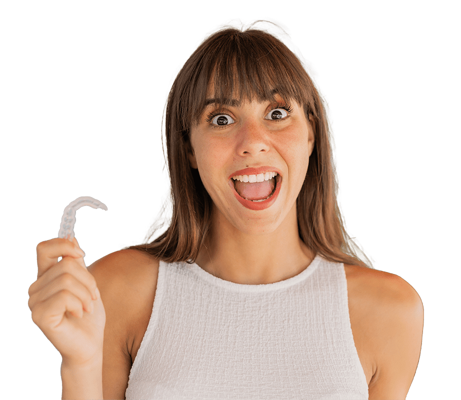 young-woman-holding-invisible-braces-outdoors-with-surprise-shocked-facial-expression-min